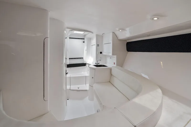 Slide: The Image of Interior of 2011 Intrepid 370 Cuddy boat, featuring sleek white design and compact amenities. - 16