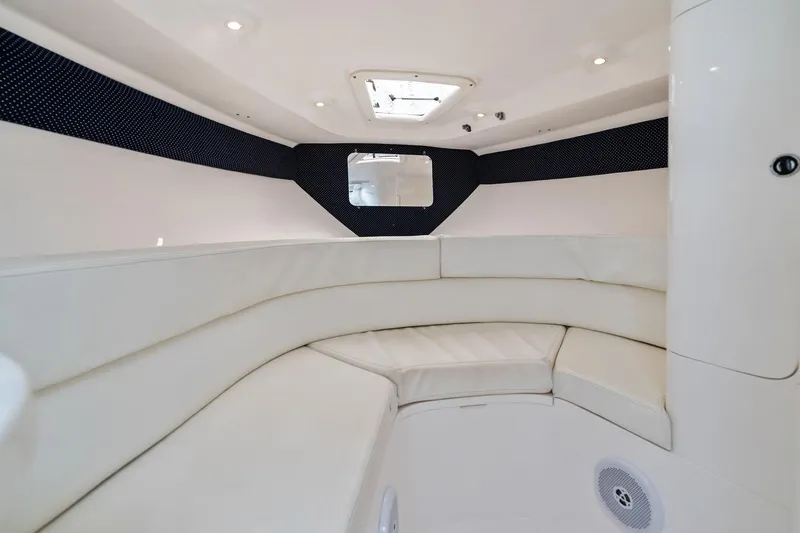 Slide: The Image of Interior of 2011 Intrepid 370 Cuddy boat, featuring white cushioned seating and modern design. - 17