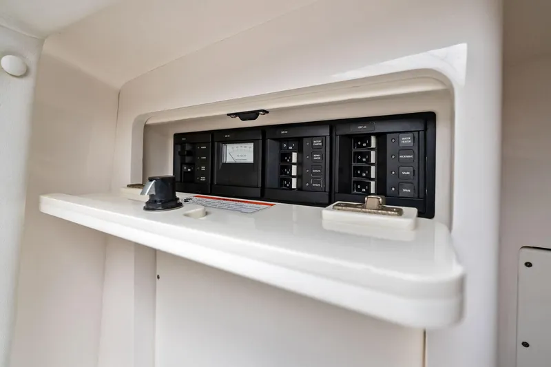 Slide: The Image of Electrical panel inside a 2011 Intrepid 370 Cuddy boat, featuring labeled switches. - 18