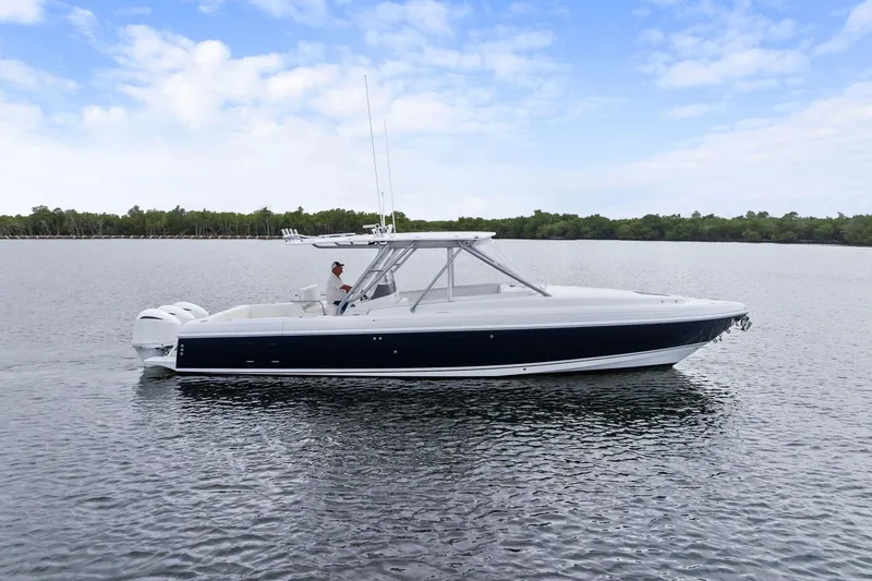 Slide: The Image of 2011 Intrepid 370 Cuddy boat cruising on calm water under a blue sky. - 4