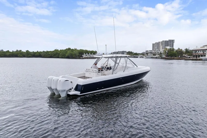 Slide: The Image of 2011 Intrepid 370 Cuddy boat on calm water with cityscape background. - 5
