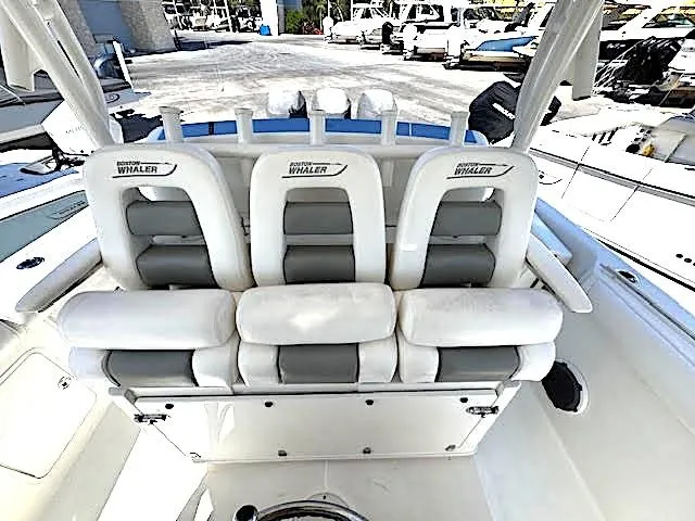 Slide: The Image of 2016 Boston Whaler 350 Outrage boat interior with white cushioned seating. - 15