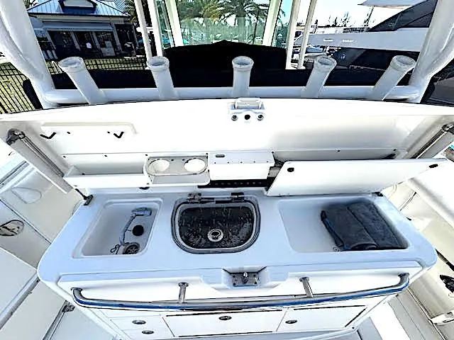 Slide: The Image of 2016 Boston Whaler 350 Outrage boat interior with fishing station and storage compartments. - 18