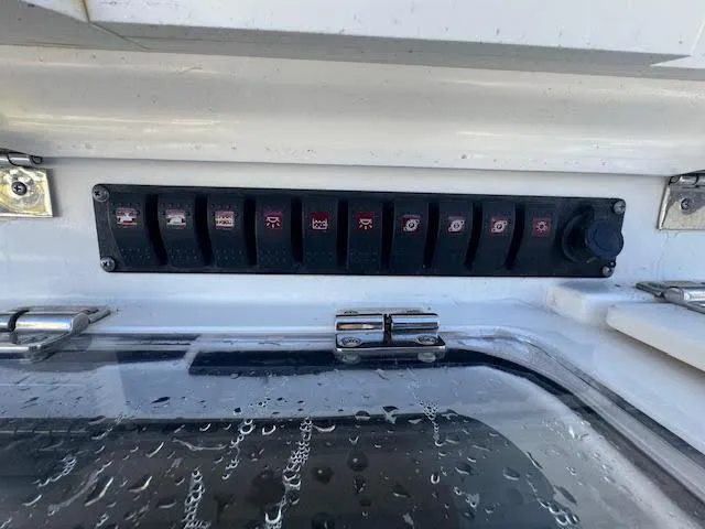 Slide: The Image of Control panel on a 2016 Boston Whaler 350 Outrage boat with multiple switches. - 19