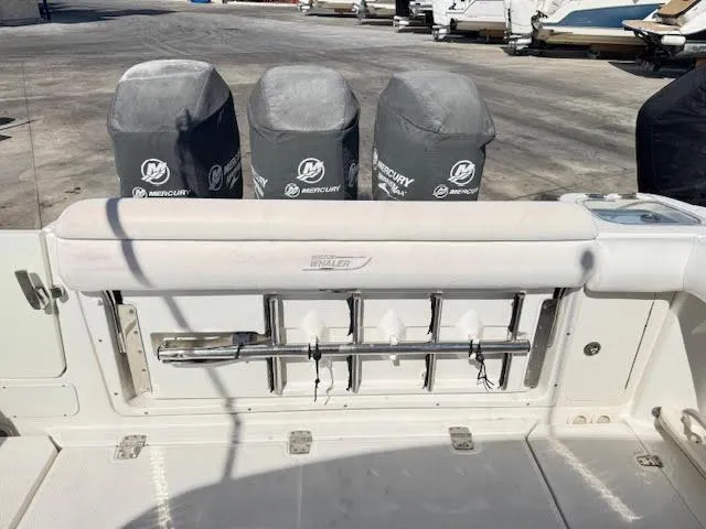 Slide: The Image of 2016 Boston Whaler 350 Outrage boat with covered Mercury engines and fishing rod holders. - 22