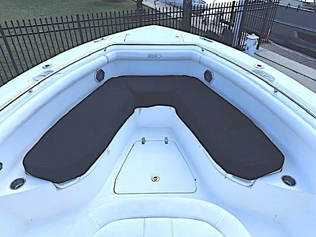 Slide: The Image of 2016 Boston Whaler 350 Outrage boat interior with cushioned seating area. - 29