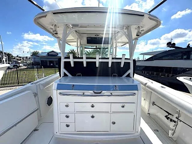 Slide: The Image of 2016 Boston Whaler 350 Outrage boat interior with rod holders and storage drawers. - 3