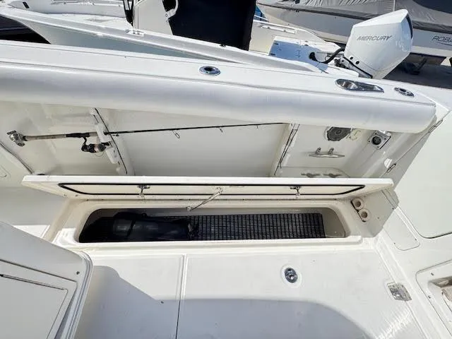 Slide: The Image of 2016 Boston Whaler 350 Outrage boat storage compartment open, showcasing interior space. - 31
