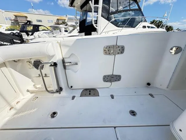 Slide: The Image of 2016 Boston Whaler 350 Outrage boat deck with storage compartments and seating. - 32