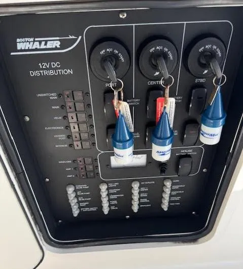 Slide: The Image of Control panel of a 2016 Boston Whaler 350 Outrage boat, featuring 12V DC distribution. - 36