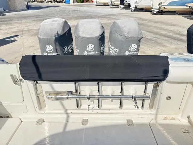 Slide: The Image of 2016 Boston Whaler 350 Outrage boat with covered Mercury engines at dock. - 37