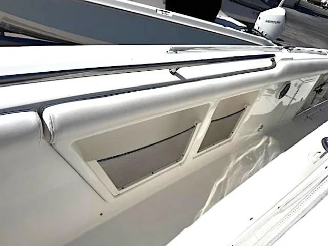 Slide: The Image of 2016 Boston Whaler 350 Outrage boat interior with storage compartments and sleek design. - 38