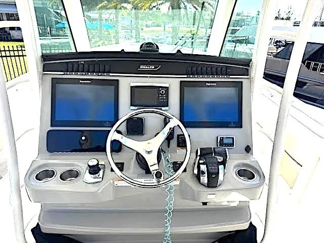 Slide: The Image of 2016 Boston Whaler 350 Outrage helm with dual screens and steering wheel. - 4