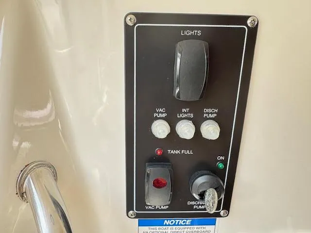 Slide: The Image of Control panel on a 2016 Boston Whaler 350 Outrage boat, featuring pump and light switches. - 41
