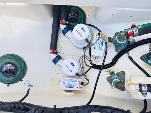 Slide: The Image of Boston Whaler 350 Outrage 2016 bilge area with pumps and wiring components. - 47