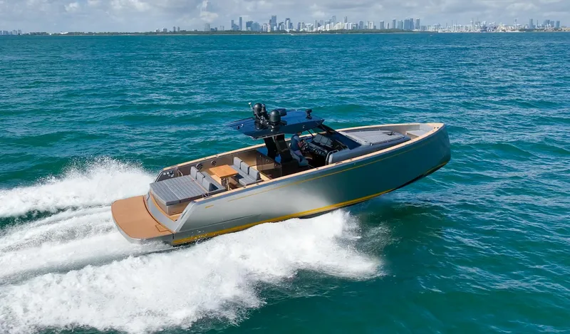 Slide: The Image of 2023 Pardo Yachts 43 cruising on open sea, city skyline in background. - 6