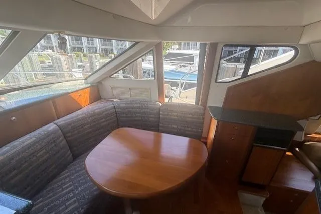 Slide: The Image of Interior of 2000 Silverton 453 Pilothouse Motor Yacht with dining area and windows. - 10