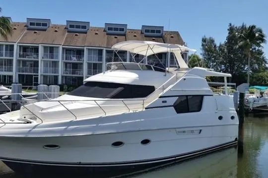 Slide: The Image of 2000 Silverton 453 Pilothouse Motor Yacht docked near waterfront buildings. - 12
