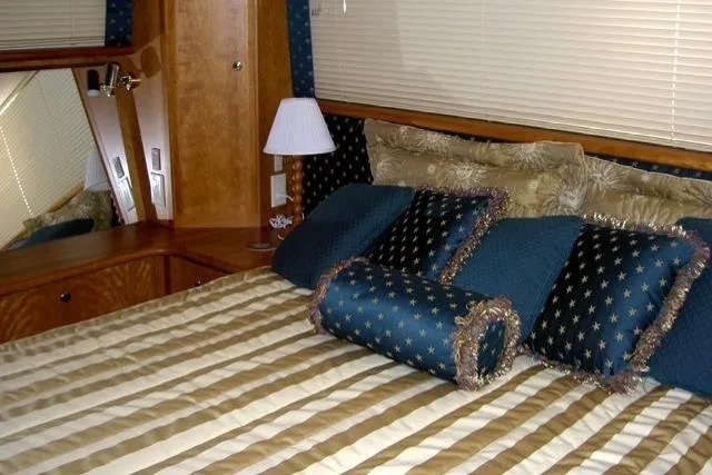 Slide: The Image of Luxurious bedroom interior of 2000 Silverton 453 Pilothouse Motor Yacht with elegant bedding. - 16