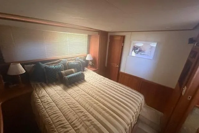 Slide: The Image of Luxurious bedroom interior of 2000 Silverton 453 Pilothouse Motor Yacht with cozy bedding. - 8