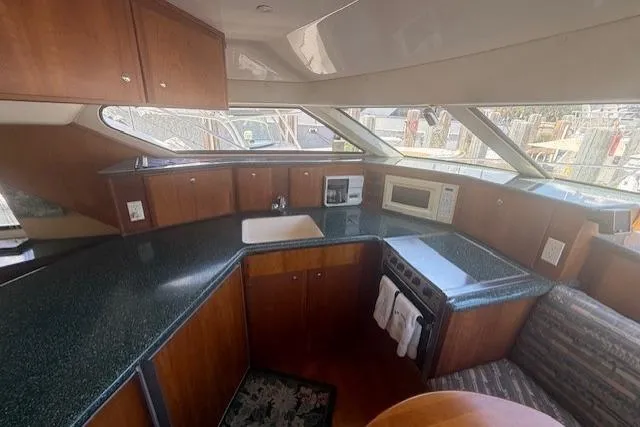 Slide: The Image of Interior of 2000 Silverton 453 Pilothouse Motor Yacht kitchen with modern amenities. - 9