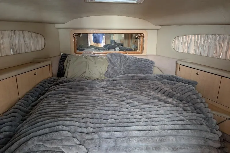 Slide: The Image of Cozy bedroom in 2000 Sea Ray 420 Aft Cabin yacht with plush bedding. - 12