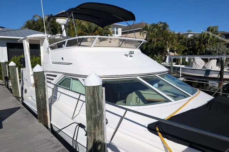 Slide: The Image of 2000 Sea Ray 420 Aft Cabin yacht docked, featuring sleek design and spacious deck. - 4