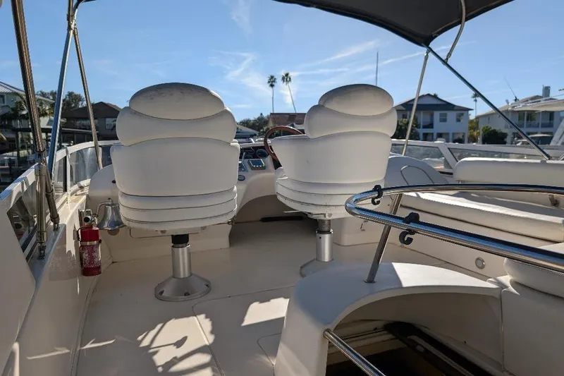 Slide: The Image of 2000 Sea Ray 420 Aft Cabin boat interior with helm chairs and canopy. - 6