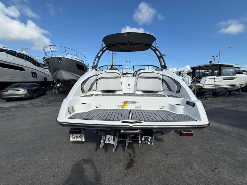 Slide: The Image of Rear view of a 2019 Yamaha AR240 boat at the marina. - 4