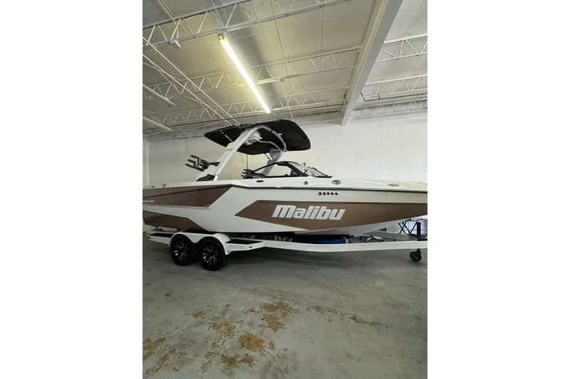 The Image of 2026 Malibu Wakesetter 24 MXZ boat in a garage, showcasing sleek design and modern features. - 0