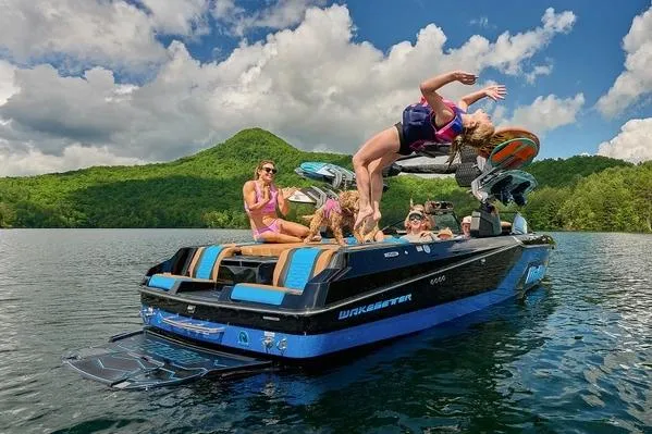 Slide: The Image of Manufacturer Provided Image: 2026 Malibu Wakesetter 24 MXZ on a lake, people enjoying water activities. - 11