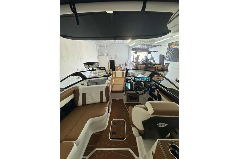 Slide: The Image of 2026 Malibu Wakesetter 24 MXZ interior with modern dashboard and luxurious seating. - 4