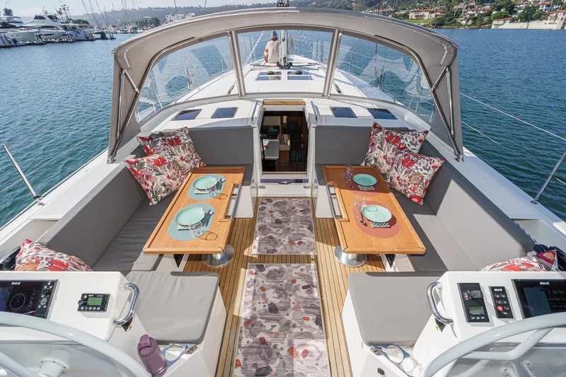 Slide: The Image of Luxurious 2023 Bavaria C50 yacht interior with elegant dining setup and scenic marina view. - 13