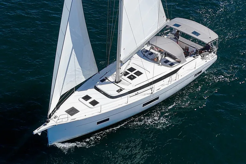 Slide: The Image of 2023 Bavaria C50 sailing yacht cruising on open water, aerial view. - 2