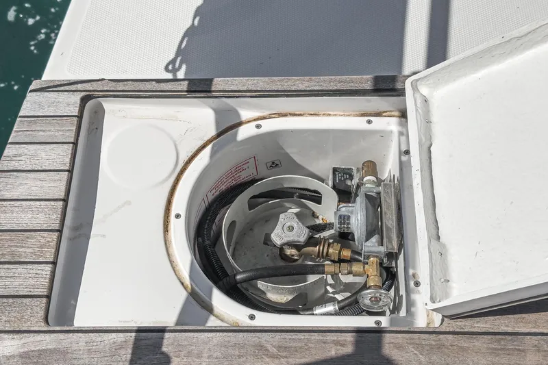 Slide: The Image of Built-in gas compartment on 2023 Bavaria C50 yacht, featuring secure fittings and hoses. - 25