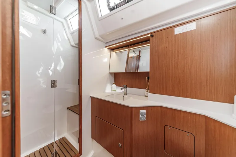 Slide: The Image of Luxurious 2023 Bavaria C50 yacht bathroom with wooden cabinetry and modern fixtures. - 49