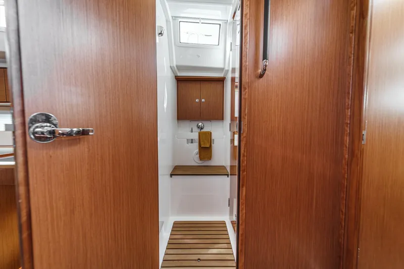 Slide: The Image of 2023 Bavaria C50 yacht interior bathroom with wooden finish and modern fixtures. - 51