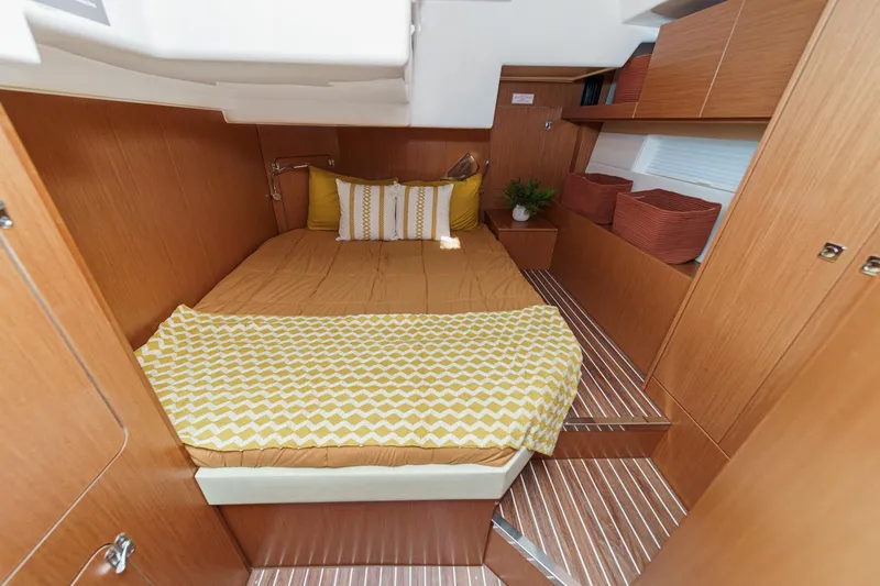 Slide: The Image of Luxurious 2023 Bavaria C50 yacht cabin with cozy bedding and elegant wood finish. - 52