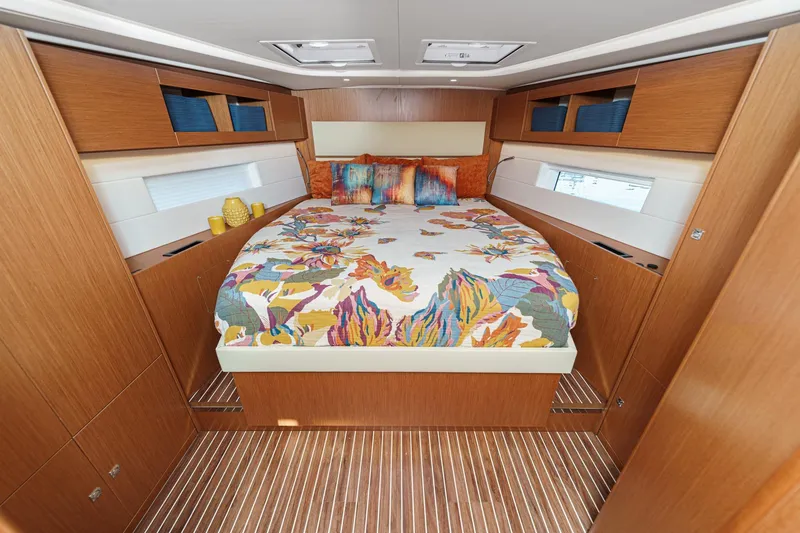 Slide: The Image of Luxurious 2023 Bavaria C50 yacht cabin with colorful bedding and wooden interior. - 56