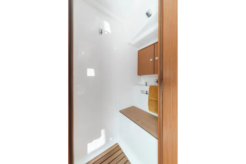 Slide: The Image of 2023 Bavaria C50 yacht interior with wooden cabinetry and modern fixtures. - 58