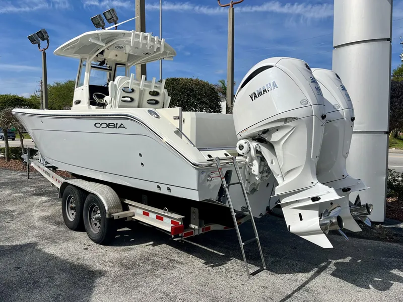 Slide: The Image of 2026 Cobia 285 Open Center Console with Yamaha engines on trailer. - 4