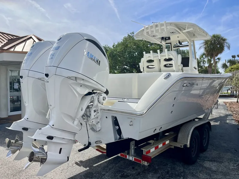 Slide: The Image of 2026 Cobia 285 Open Center Console with Yamaha engines on trailer. - 6