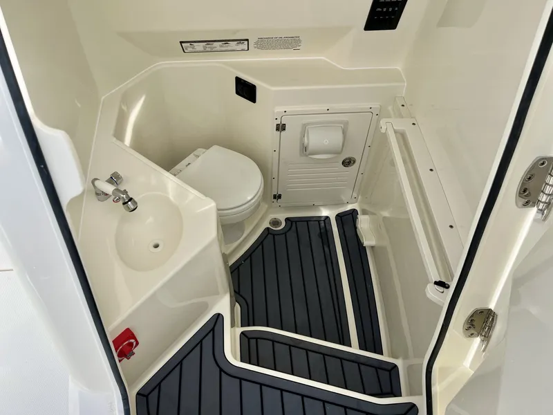 Slide: The Image of Interior of 2026 Cobia 285 Open Center Console with toilet and sink. - 20