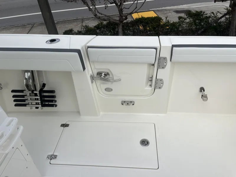 Slide: The Image of Cobia 285 Open Center Console 2026, boat deck view with storage. - 33