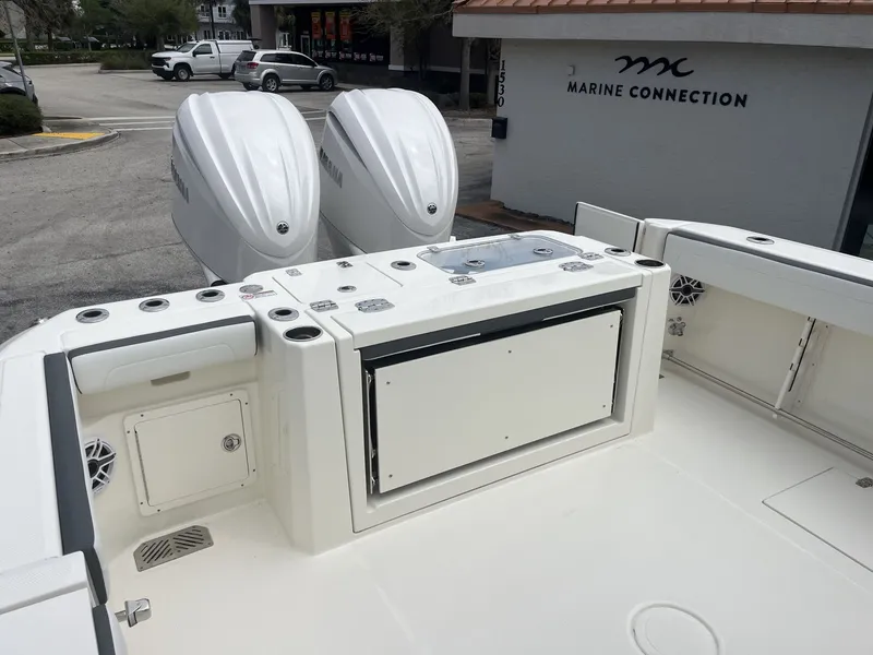 Slide: The Image of 2026 Cobia 285 Open Center Console with dual outboard engines. - 28