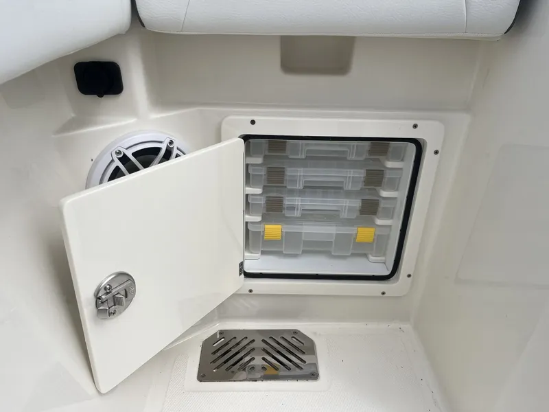Slide: The Image of Cobia 285 Open Center Console 2026, storage compartment with speaker. - 29