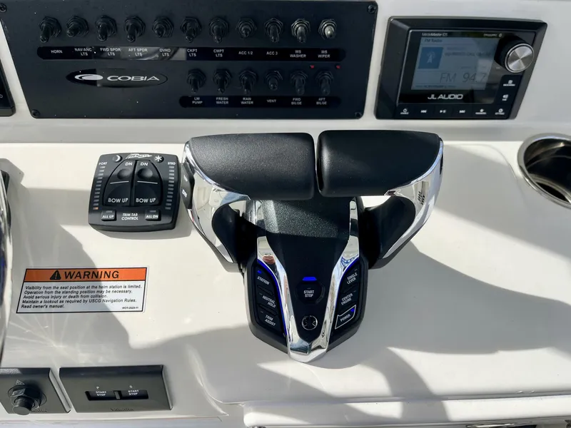 Slide: The Image of 2026 Cobia 285 Open Center Console dashboard controls. - 14