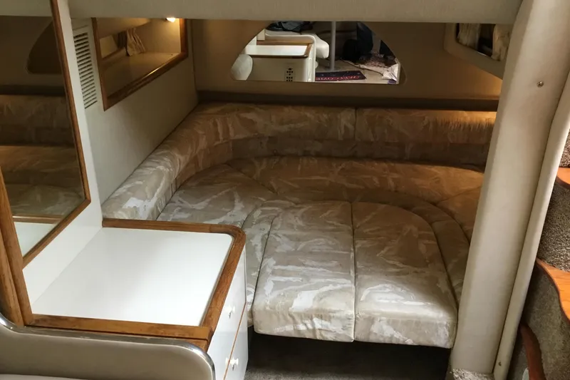 Slide: The Image of Interior of a 1995 Sea Ray Sundancer 370 with beige seating and wooden accents. - 11