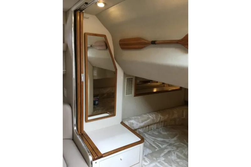 Slide: The Image of Interior cabin of 1995 Sea Ray Sundancer 370 with mirror and wooden accents. - 12