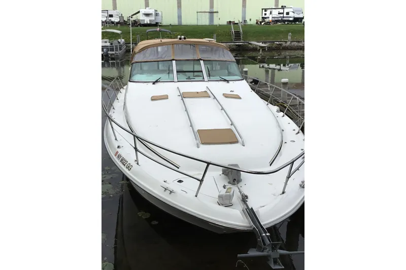 Slide: The Image of 1995 Sea Ray Sundancer 370 docked, featuring a sleek white design and tan accents. - 3